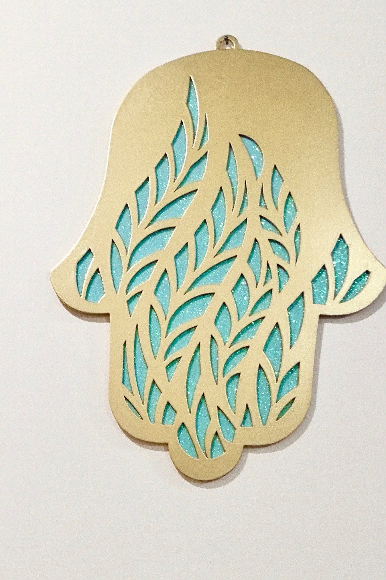 Close-up of handmade metal Hamsa wall hanging with geometric pattern from Israel